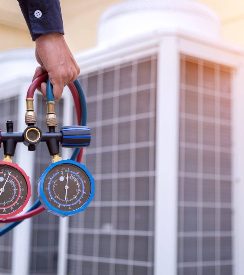 Technician is checking air conditioner ,measuring equipment for filling air conditioners.